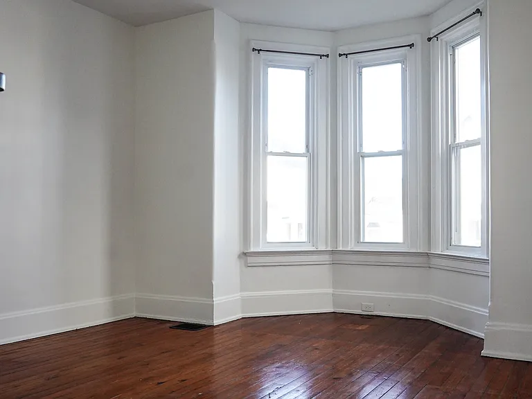 Beautiful bay window floods the living room with natural light.