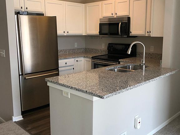 Kitchen is equipped with electric stove, microwave, garbage disposal and fridge with a bottom drawer freezer. Lots of counter space!