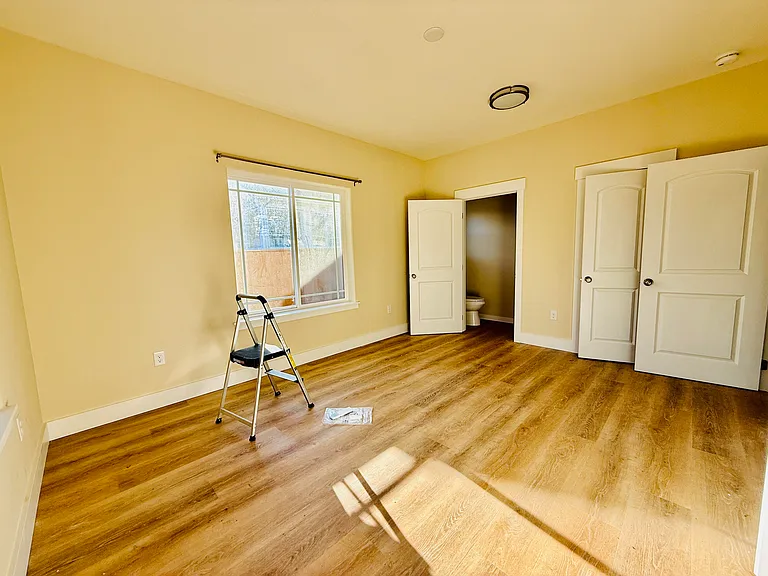 12'x15' primary bedroom has ensuite half bath and 2 large closets
