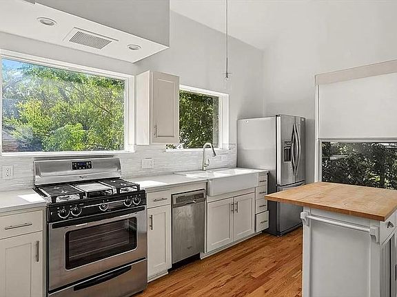 Kitchen with butcher block island.
