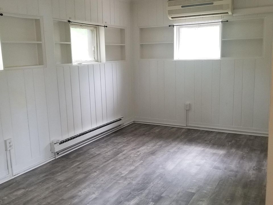 Full living room view. Above the center window is the AC split system. It keeps the whole unit cool.