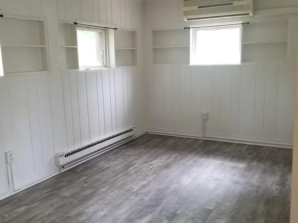 Full living room view. Above the center window is the AC split system. It keeps the whole unit cool.