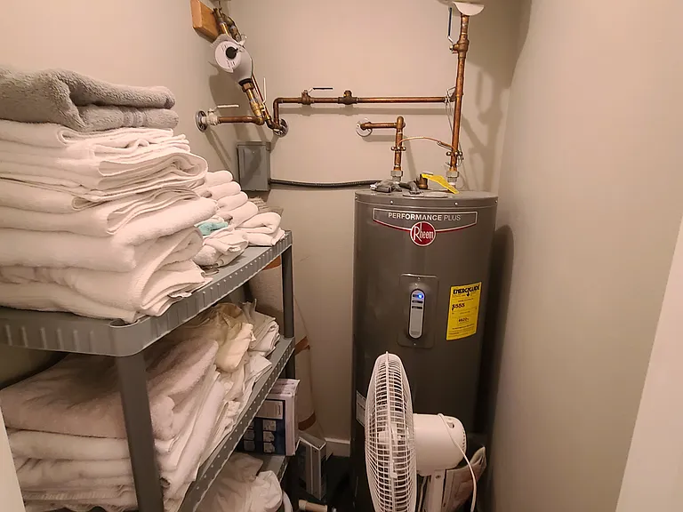 Plenty of linens and towels in storage room across from laundry room