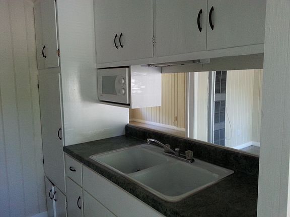 Kitchen sink area open to living
