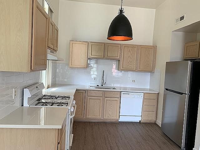 Newly equipped kitchen: new countertop, refrigerator, range, sink, and flooring