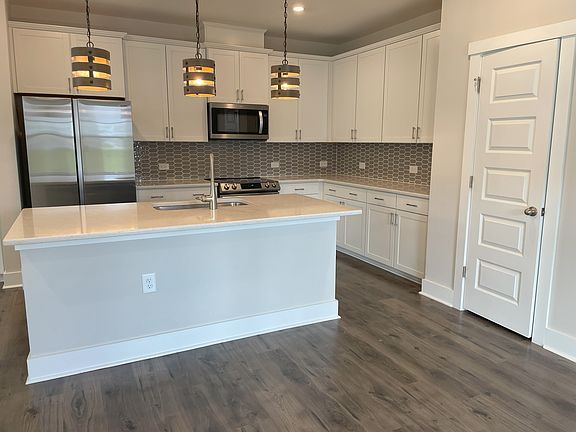 Stainless appliances and solid surface counters, island with bar seating