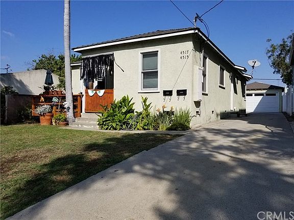 Front house with driveway to back-unit, 2-car garage, and extra parking