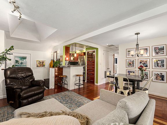 Lovely open living/dining room area with skylights