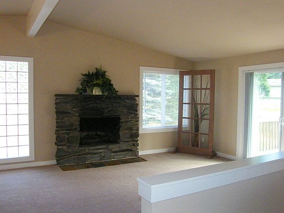 Great room off kitchen with new carpet, new windows, new doors, new paint, etc