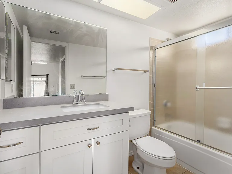 Remodeled Primary Bathroom. NEW fixtures, tub/shower, paint, lights, cabinets, flooring.