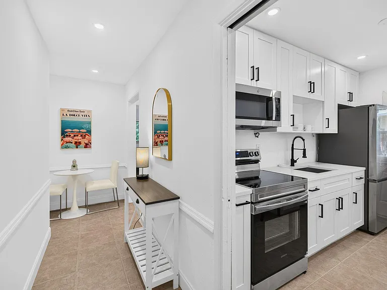 Updated kitchen with ample cabinet storage, stainless appliances, and a nearby bistro nook for everyday meals.