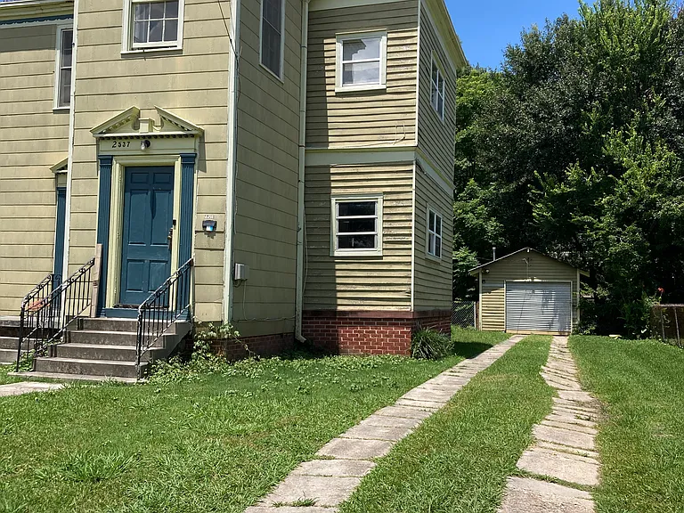 Front entrance, private driveway and shed.