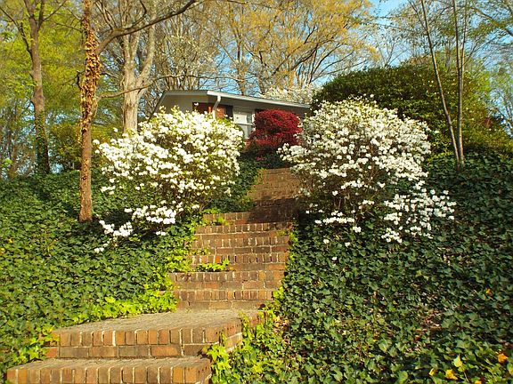 Side of Exterior during Azelia Season. Driveway Leads to Back Parking Area.