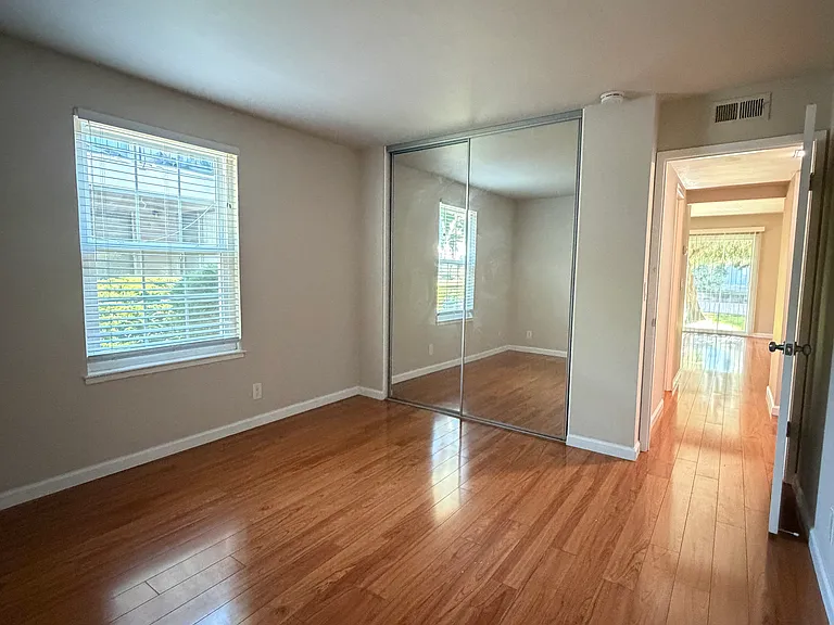 Bedroom 1 features mirrored closet doors