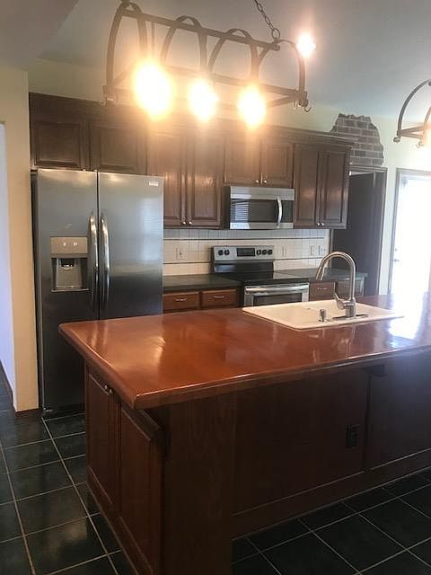 Kitchen with Stainless Steel Appliances and Island Bar