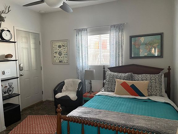 Main room with full size bed, dresser, chair