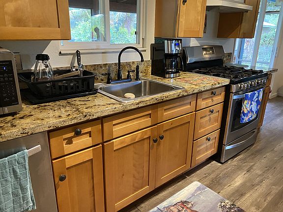 Granite countertops, stainless steel appliances, including dishwasher, gas stove, refrigerator