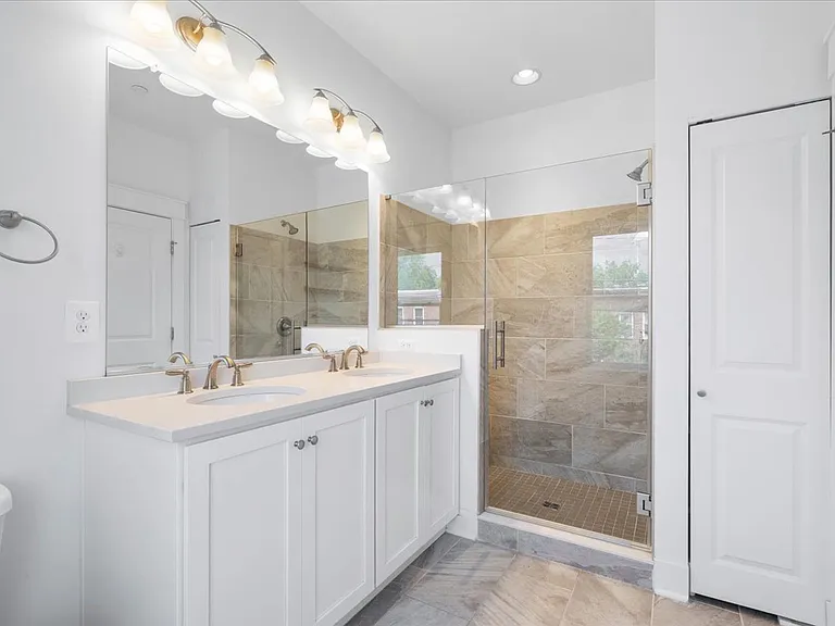 Primary bathroom with sleek frameless glass shower and double vanity