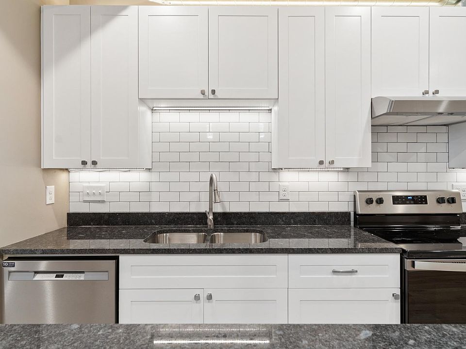 This shows more of the kitchen-subway tile and stainless steel sink