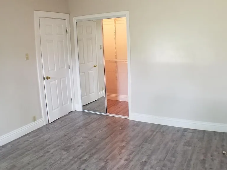Master bedroom has mirrored closet door