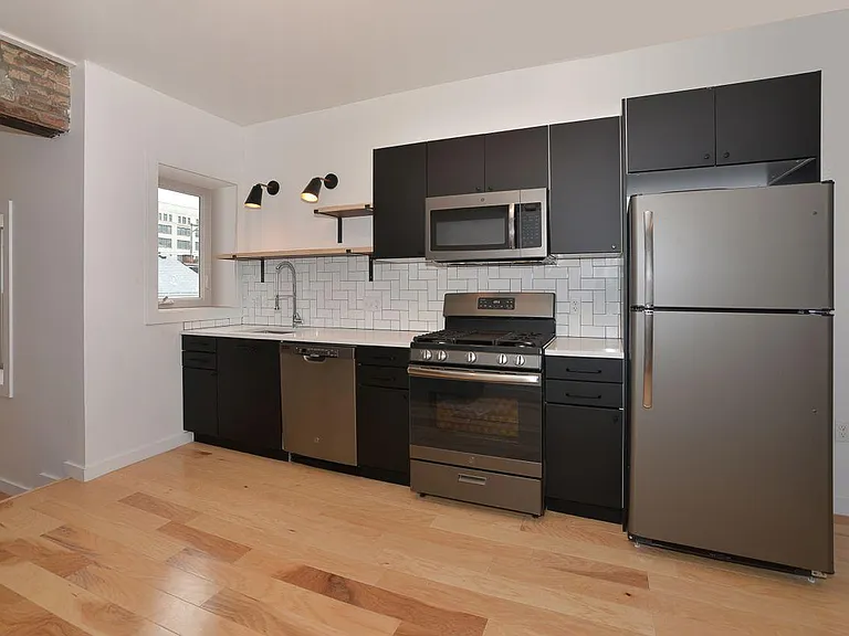 Quartz kitchen with pantry & built-in wine fridge on opposite wall