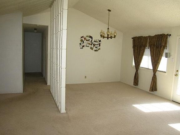 Combined living and dining. Wall decoration or drapes are no