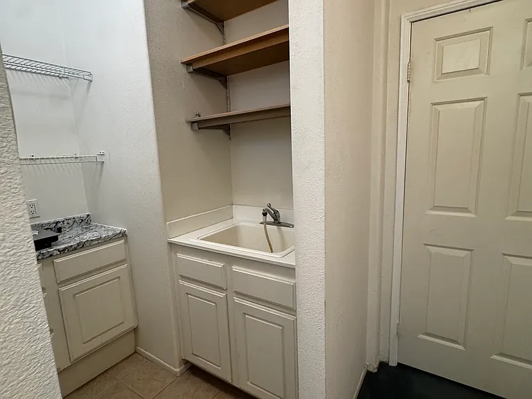 plenty of shelves, counter+ sink + laundry machines. Door in photo separates N. wing hallway and rental rooms from home-owner area. Home owner will share washer/dryer with tenants but tenants and owners will have own designated laundry day for privacy.