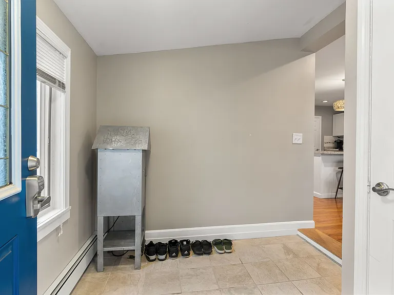 View of the entry area featuring a tiled floor, neutral walls, and space for shoe storage.