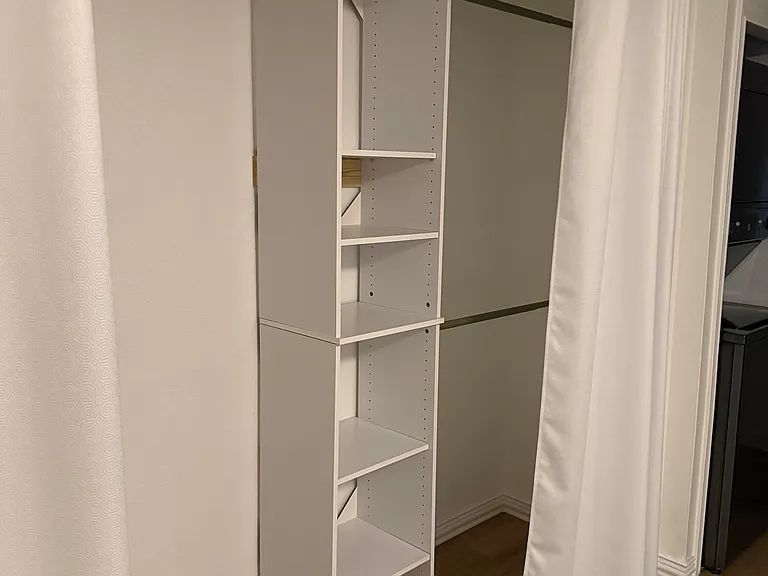 Closet with organizer shelves and rods.