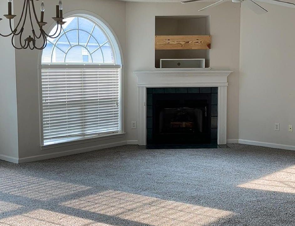 Extra large living area with fireplace and lots of natural light.