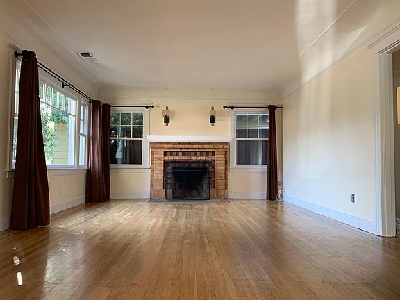 Spacious living room with large windows and high ceiling