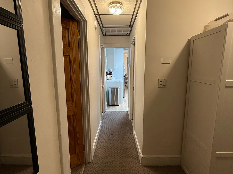Hall looking towards kitchen. Getting new floors, walls, ceiling and lighting.