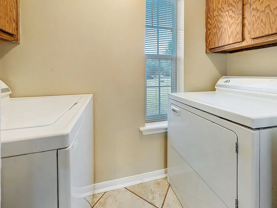 Convenient in-unit laundry area with full-sized appliances.