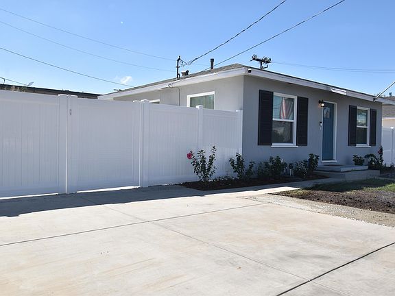 New vinyl fencing with double gate to pull through extra vehicles or toys to the back yard