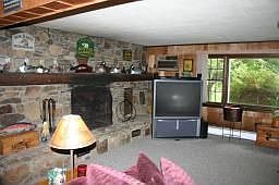 One of a kind Stone Fireplace with Wood Storage 