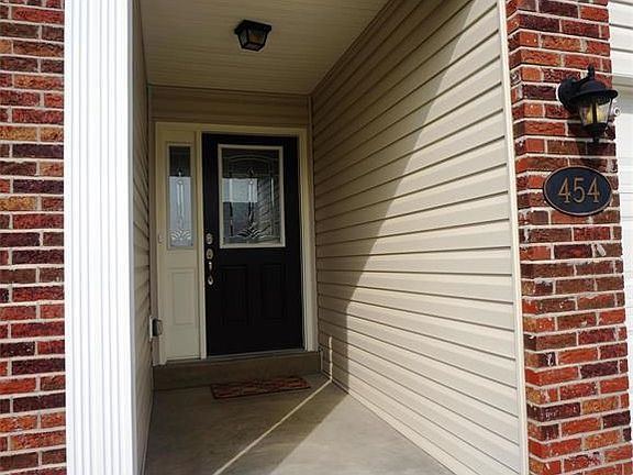 Covered porch invites you to the upgraded, lead glass entry door with sidelight.