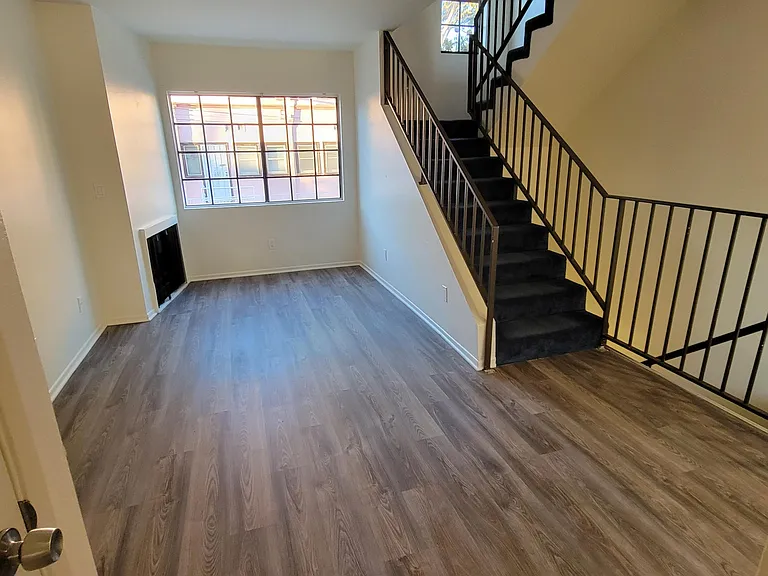 Living Rm, Gas Fireplace, Window View and Stairs to Bedrooms/Bathrooms