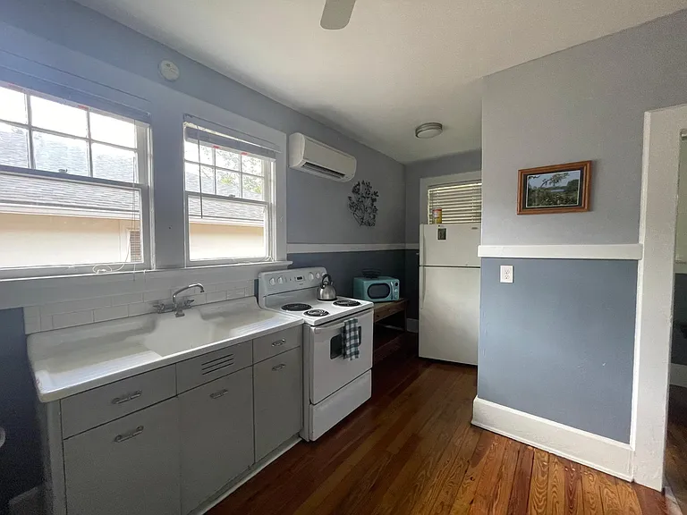 Kitchen includes stove, oven, microwave and refrigerator.
