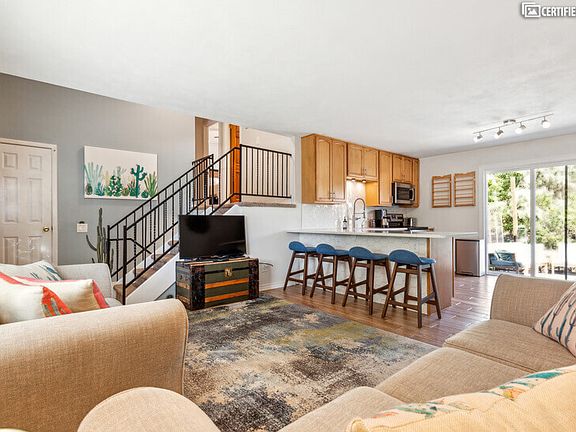 Living room, kitchen, sliding doors to patio and backyard