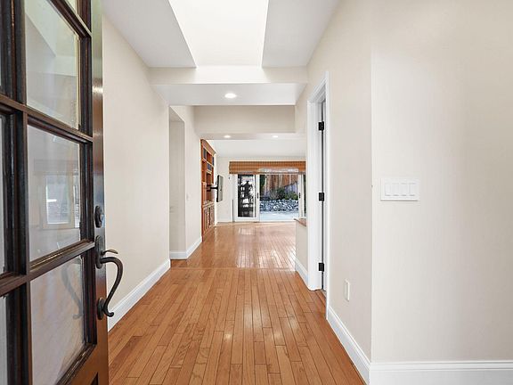 The entryway and main living spaces are accentuated with soaring ceilings, an open concept, ample storage, and an abundance of natural light.