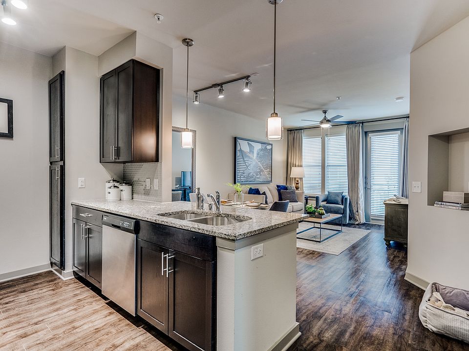 luxury kitchen with granite countertops, stainless steel appliances, and dark wood cabinetry