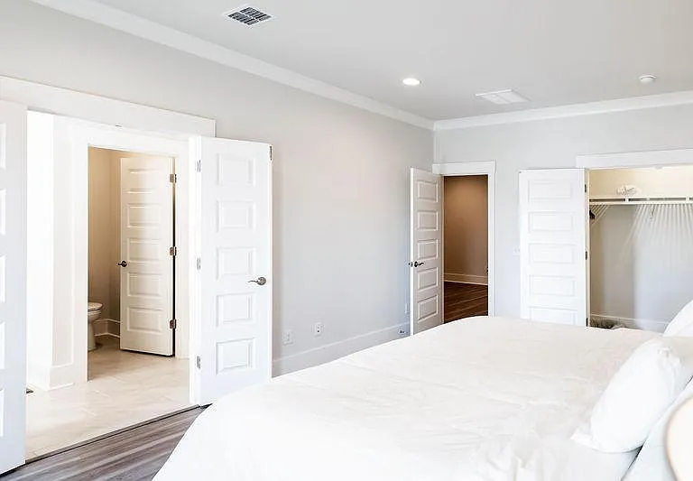 Primary suite, featuring dual closets! One on the right and the large walk in is located in the en suite bathroom