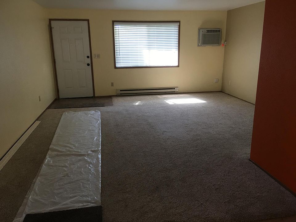 Living room view from dining area to front entrance door..