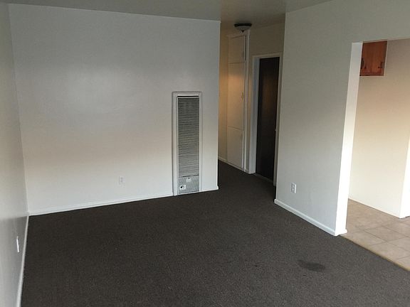 View form Front Door: living room, door to bathroom and hallway leading to bedroom. CARPET WILL BE TAKEN OUT AND REPLACED BY LAMINATE FLOORING.