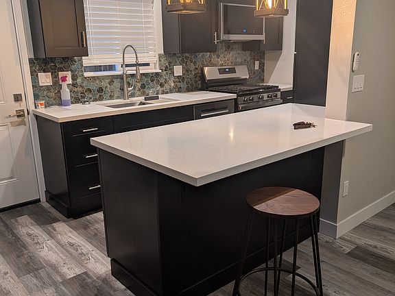 Different view of kitchen with breakfast bar.