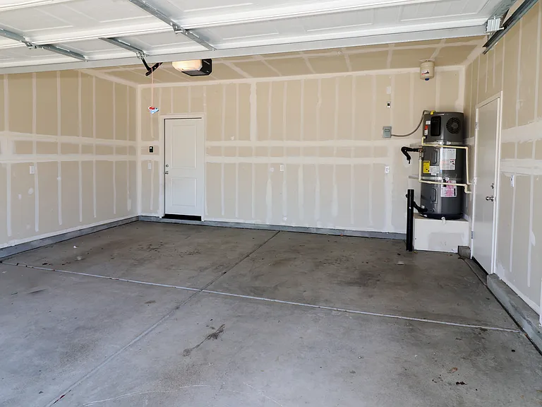 Spacious 2-car garage. That's an energy efficient hybrid hot water heater in the far right corner.