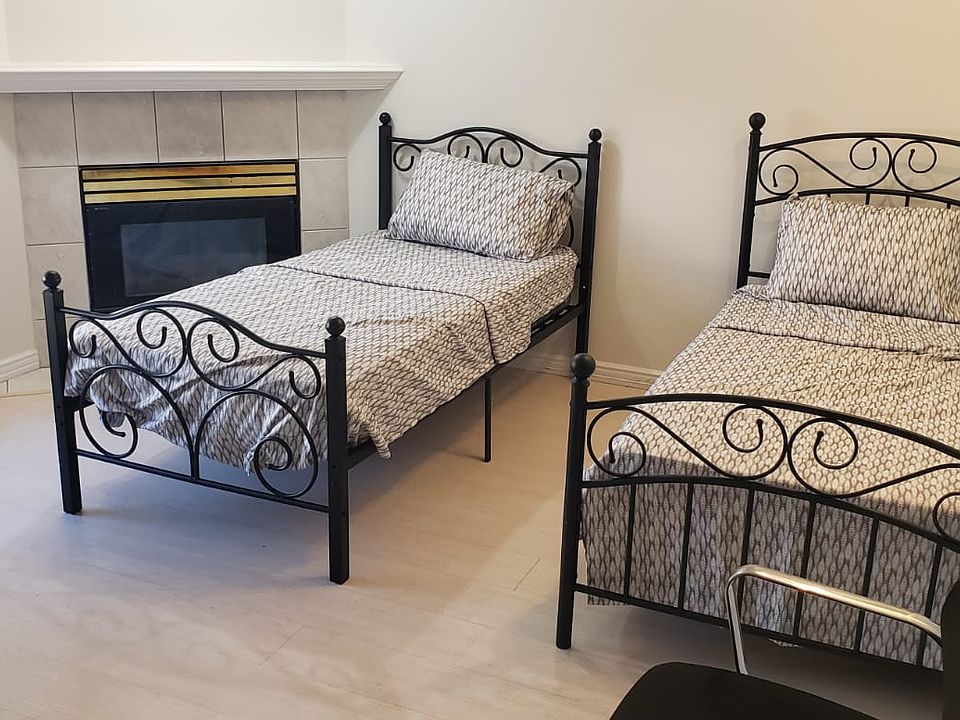Two comfortable beds with a large window viewing the backyard.