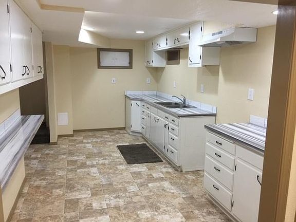 Kitchen is large with more than enough cupboards. There is a pull out rack in one cupboard with 2-13 gallon garbage cans