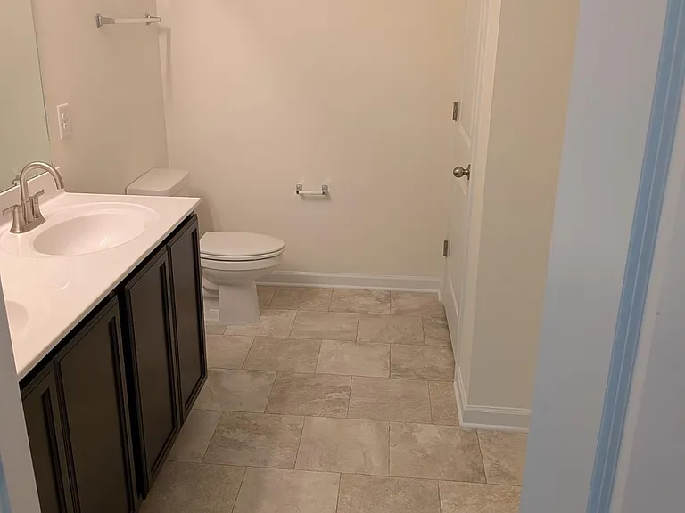 Spacious owner's suite bathroom featuring a double vanity, cultured marble countertops, and plenty of room for your daily routine.