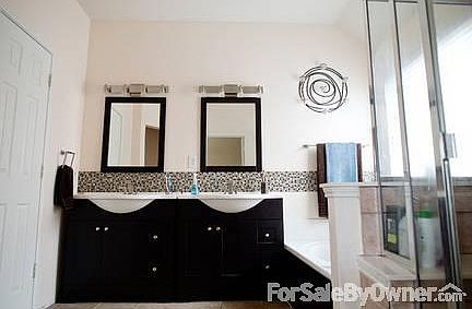 Master Bathroom
						:
						His and Hers vanities, mirrors and lights. Jetted garden tub and tiled shower.
